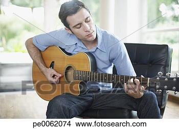 man-sitting-living_~pe0062074.jpg