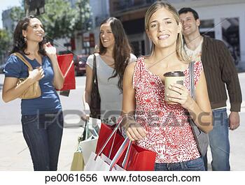 Stock Photo - four friends outdoors 
carrying shopping 
bags and smiling. 
fotosearch - search 
stock photos, 
pictures, images, 
and photo clipart