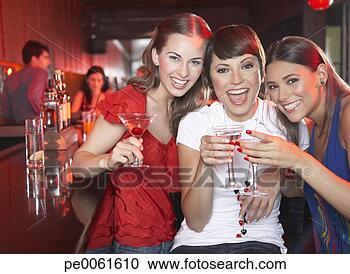 Stock Photography - three women with 
beverages in nightclub 
toasting and smiling. 
fotosearch - search 
stock photos, 
pictures, images, 
and photo clipart