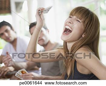 Stock Photo - woman winning 
a card game to 
two friends at 
a table. fotosearch 
- search stock 
photos, pictures, 
images, and photo 
clipart