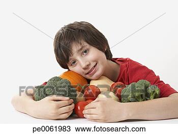 Stock Photo - boy hugging a 
pile of assorted 
vegetables smiling. 
fotosearch - search 
stock photos, 
pictures, images, 
and photo clipart
