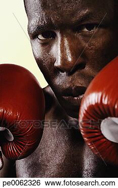 Stock Photo - boxer wearing 
gloves looking 
intimidating. 
fotosearch - search 
stock photos, 
pictures, images, 
and photo clipart