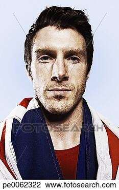 Stock Photo - man standing with 
the british flag 
around his shoulders. 
fotosearch - search 
stock photos, 
pictures, images, 
and photo clipart