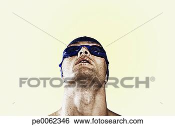 Stock Photo - wet swimmer wearing 
cap and goggles 
looking up. fotosearch 
- search stock 
photos, pictures, 
images, and photo 
clipart