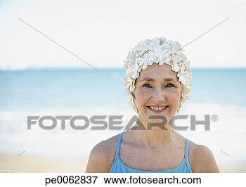 Picture - mature woman in 
old-fashioned 
swim cap on beach. 
fotosearch - search 
stock photos, 
pictures, images, 
and photo clipart