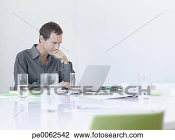 Stock Photo - businessman working 
on laptop. fotosearch 
- search stock 
photos, pictures, 
images, and photo 
clipart