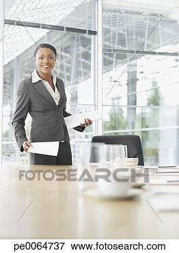Picture - businesswoman 
with paperwork 
in conference 
room. fotosearch 
- search stock 
photos, pictures, 
images, and photo 
clipart