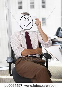 Picture - businessman holding 
picture of angry 
face. fotosearch 
- search stock 
photos, pictures, 
images, and photo 
clipart
