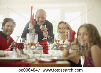 Picture - family enjoying 
christmas dinner. 
fotosearch - search 
stock photos, 
pictures, images, 
and photo clipart