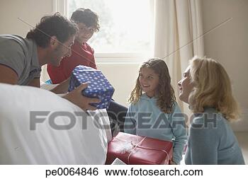 Stock Photo - family opening 
christmas gifts. 
fotosearch - search 
stock photos, 
pictures, images, 
and photo clipart