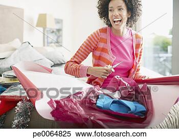 Stock Image - woman wrapping 
christmas gift. 
fotosearch - search 
stock photos, 
pictures, images, 
and photo clipart