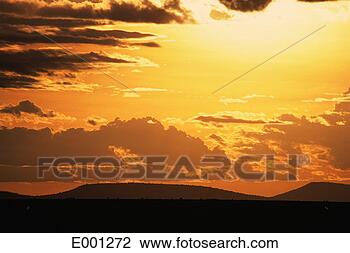Stock Photo - serengeti sunset 
with clouds and 
mountain. fotosearch 
- search stock 
photos, pictures, 
images, and photo 
clipart