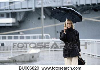 Stock Photography - businesswoman 
walking in rain. 
fotosearch - search 
stock photos, 
pictures, images, 
and photo clipart