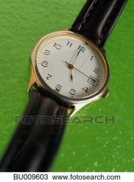 Stock Photo - close-up of wristwatch 
showing five o'clock. 
fotosearch - search 
stock photos, 
pictures, images, 
and photo clipart