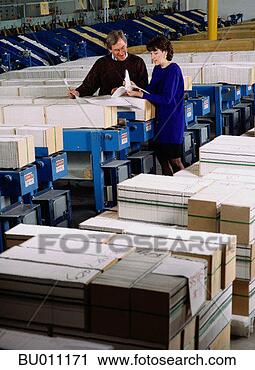 Stock Photography - man and woman 
in a printing 
factory. fotosearch 
- search stock 
photos, pictures, 
images, and photo 
clipart