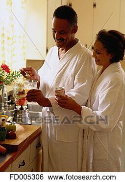 Stock Photo - couple adding 
a nutrition supplement 
to juice. fotosearch 
- search stock 
photos, pictures, 
images, and photo 
clipart