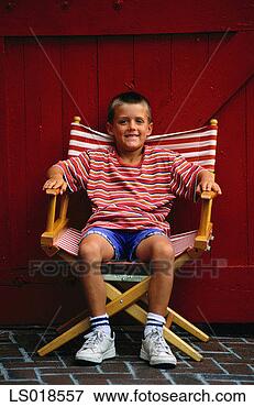Picture - boy sitting in 
director's chair. 
fotosearch - search 
stock photos, 
pictures, images, 
and photo clipart
