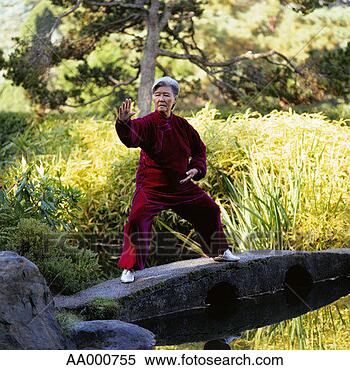 Stock Image - woman performing 
tai chi chuan. 
fotosearch - search 
stock photos, 
pictures, images, 
and photo clipart