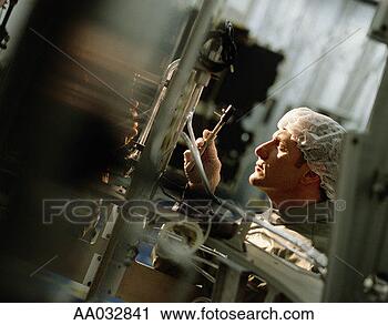 Stock Photography - technician assembling 
a motor unit for 
a satellite. fotosearch 
- search stock 
photos, pictures, 
images, and photo 
clipart