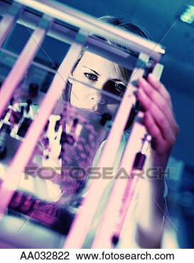 Stock Photo - woman looking 
at specimens in 
a lab. fotosearch 
- search stock 
photos, pictures, 
images, and photo 
clipart