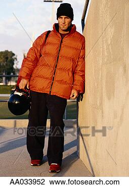Stock Photo - young man holding 
footbal helmet. 
fotosearch - search 
stock photos, 
pictures, images, 
and photo clipart