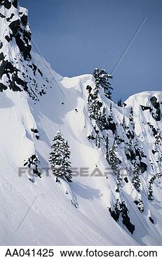 Stock Image - skier descends 
steep powder slope. 
fotosearch - search 
stock photos, 
pictures, images, 
and photo clipart