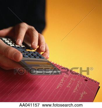 Picture - student using 
calculator, with 
notebook. fotosearch 
- search stock 
photos, pictures, 
images, and photo 
clipart