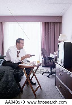 Stock Photography - businessman watching 
tv in hotel room. 
fotosearch - search 
stock photos, 
pictures, images, 
and photo clipart
