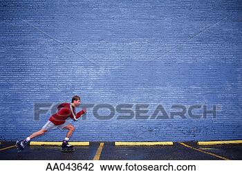 Stock Photo - young man inline 
skating in parking 
lot. fotosearch 
- search stock 
photos, pictures, 
images, and photo 
clipart