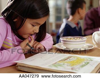 Stock Photograph - 6-year-old girl 
doing homework 
during breakfast. 
fotosearch - search 
stock photos, 
pictures, images, 
and photo clipart