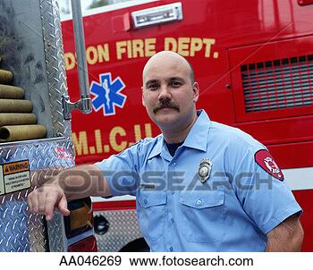 Stock Photograph - fireman standing 
in front of fire 
engine. fotosearch 
- search stock 
photos, pictures, 
images, and photo 
clipart