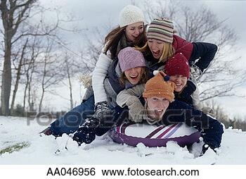 Stock Photo - friends piled 
on top of inflatable 
intertube in the 
snow. fotosearch 
- search stock 
photos, pictures, 
images, and photo 
clipart
