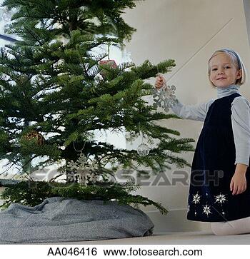 Stock Photo - girl decorating 
a christmas tree. 
fotosearch - search 
stock photos, 
pictures, images, 
and photo clipart