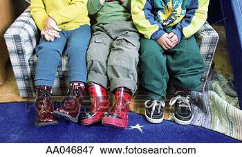 Picture - legs and feet 
of children sitting 
on sofa. fotosearch 
- search stock 
photos, pictures, 
images, and photo 
clipart