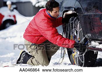Stock Photo - man putting chains 
on tires in snow. 
fotosearch - search 
stock photos, 
pictures, images, 
and photo clipart