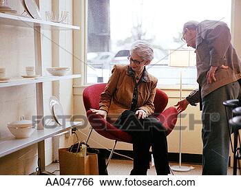 Stock Photo - mature couple 
shopping for chair 
at a modern furniture 
store. fotosearch 
- search stock 
photos, pictures, 
images, and photo 
clipart