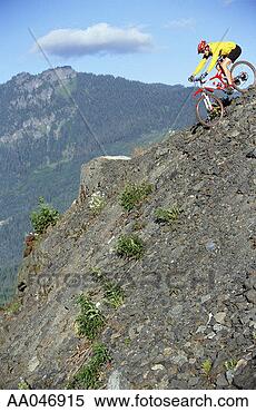 Stock Image - mountain biker 
riding down rocky 
hill. fotosearch 
- search stock 
photos, pictures, 
images, and photo 
clipart