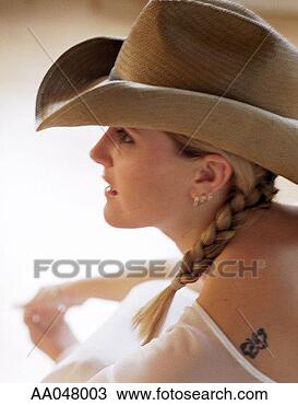 Stock Photo - portrait of young 
woman wearing 
cowboy hat. fotosearch 
- search stock 
photos, pictures, 
images, and photo 
clipart