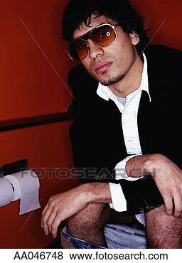 Stock Photo - trendy young man 
wearing sunglasses 
while sitting 
on a toilet. fotosearch 
- search stock 
photos, pictures, 
images, and photo 
clipart