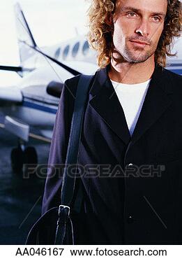 Picture - young businessman 
standing near 
airplane. fotosearch 
- search stock 
photos, pictures, 
images, and photo 
clipart