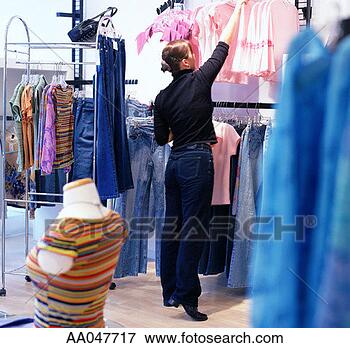 Picture - young woman in 
clothing store. 
fotosearch - search 
stock photos, 
pictures, images, 
and photo clipart