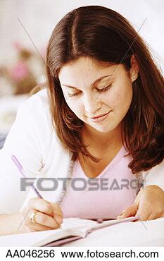 Stock Photo - young woman writing 
in journal. fotosearch 
- search stock 
photos, pictures, 
images, and photo 
clipart