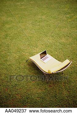 Picture - laptop sitting 
on lounge chair. 
fotosearch - search 
stock photos, 
pictures, images, 
and photo clipart