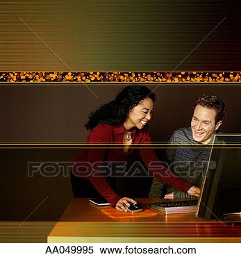 Stock Image - young man and 
young woman work 
with flat screen 
monitor. fotosearch 
- search stock 
photos, pictures, 
images, and photo 
clipart