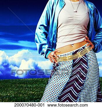 Stock Photography - young woman standing 
in field, mid 
section. fotosearch 
- search stock 
photos, pictures, 
images, and photo 
clipart