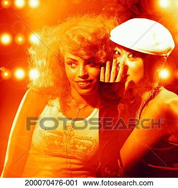 Stock Photography - young woman whispering 
in another young 
woman's ear, portrait. 
fotosearch - search 
stock photos, 
pictures, images, 
and photo clipart