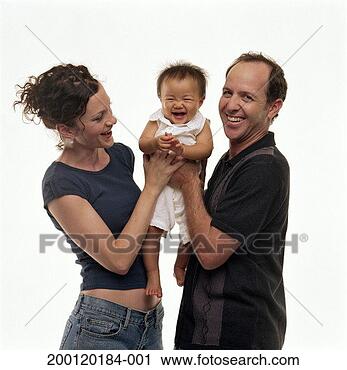 Stock Photography - couple holding 
adopted baby girl 
(9-12 months), 
portrait. fotosearch 
- search stock 
photos, pictures, 
images, and photo 
clipart