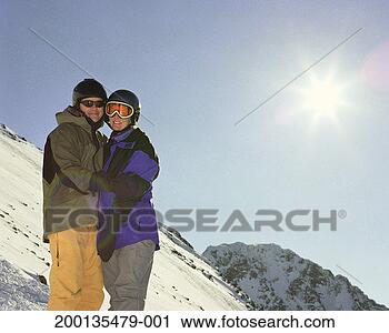 Stock Photography - couple on ski 
slope, smiling, 
portrait. fotosearch 
- search stock 
photos, pictures, 
images, and photo 
clipart