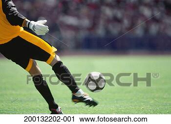 Stock Photography - goalkeeper kicking 
football, low 
section (blurred 
motion). fotosearch 
- search stock 
photos, pictures, 
images, and photo 
clipart