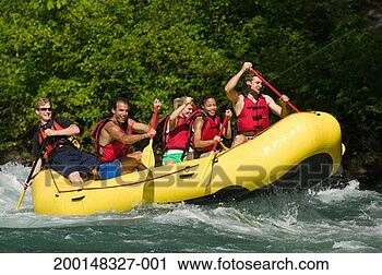 Stock Photography - five young people 
paddling raft 
on river rapids, 
side view. fotosearch 
- search stock 
photos, pictures, 
images, and photo 
clipart
